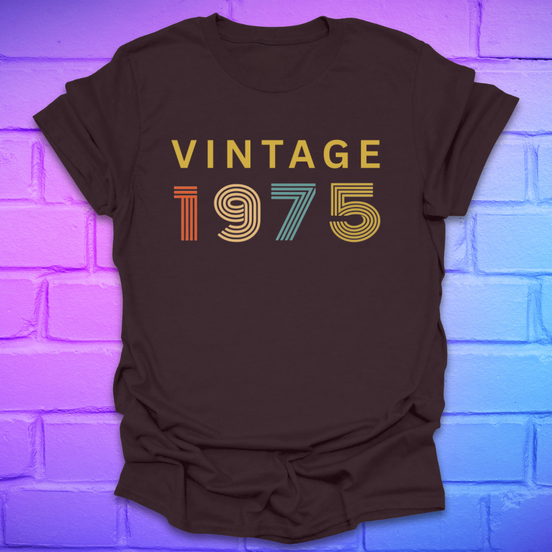 Brown tshirt with text 'Vintage 1975' in a retro font, on a brick background.