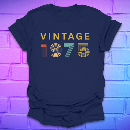 Navy blue tshirt with text 'Vintage 1975' in a retro font, on a brick background.