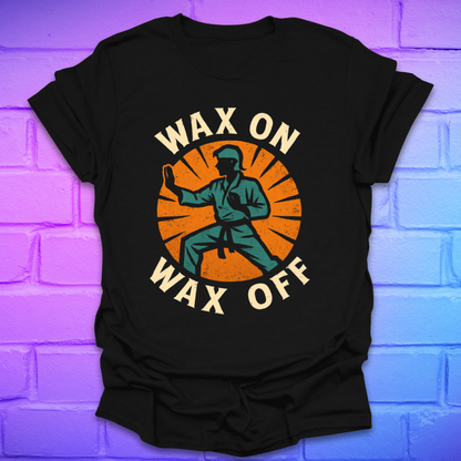 Black t-shirt with 'Wax On Wax Off' graphic design on a brick wall background