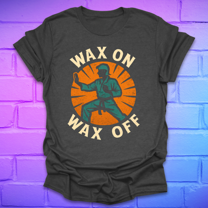 Dark gray t-shirt with 'Wax On Wax Off' graphic design on a brick wall background