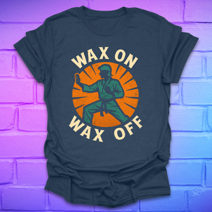 light navy T-shirt with 'Wax On Wax Off' graphic design on a brick wall background