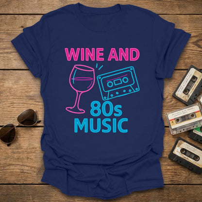 Navy blue t-shirt with 'Wine and 80s Music' design on a wooden surface with cassettes and sunglasses.