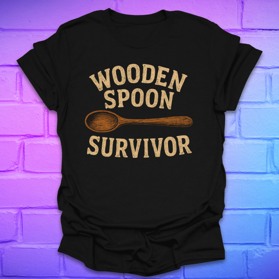 Black t-shirt with 'Wooden Spoon Survivor' text and wooden spoon graphic on a brick wall background